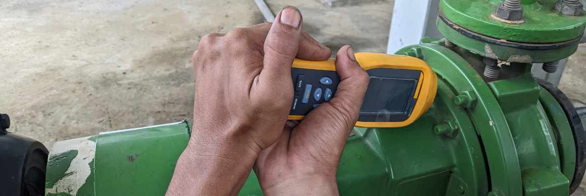Man worker measure vibration motor and pump on power plant project.
